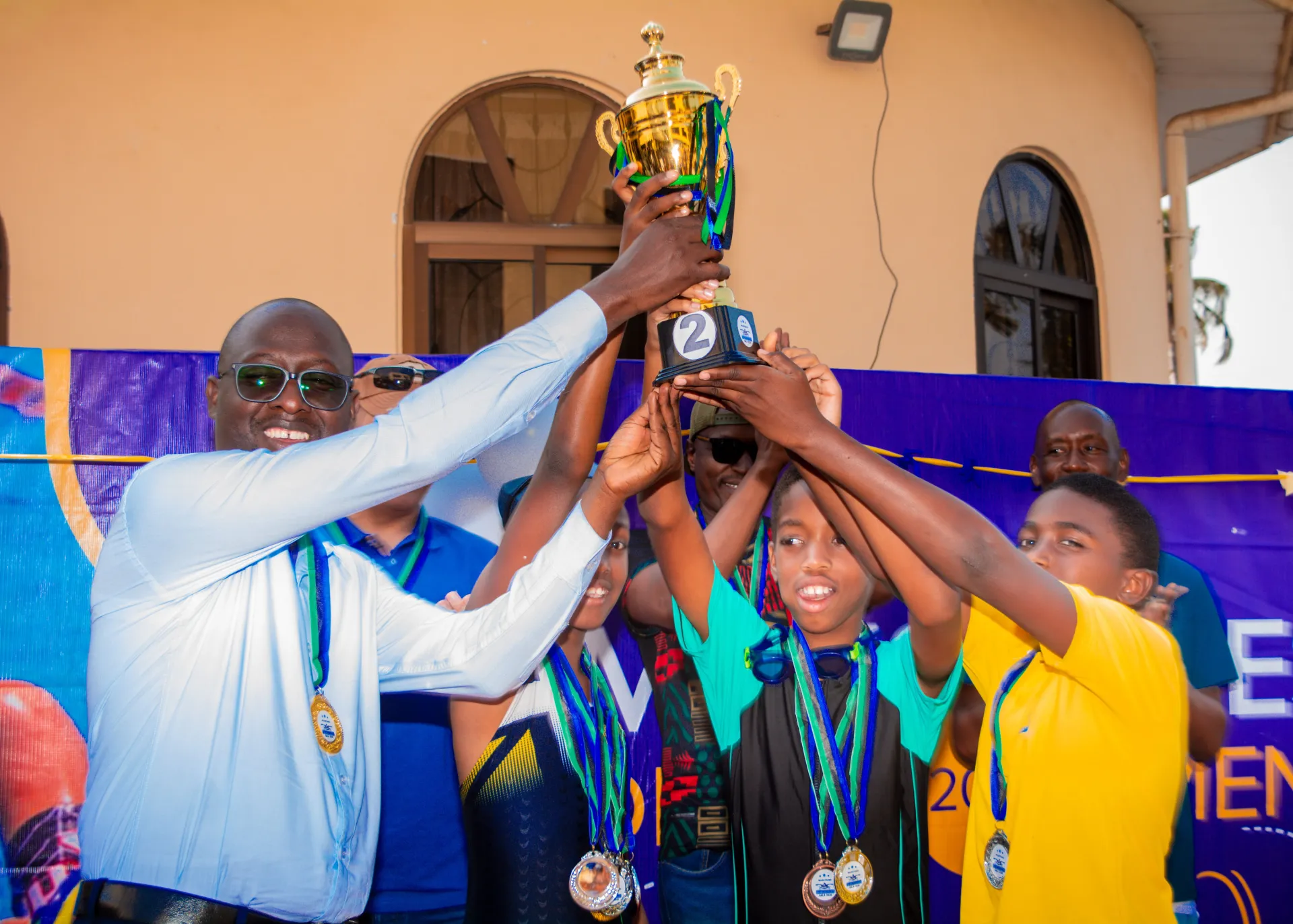 Milestones Academy swimmers receiving their runners-up trophy