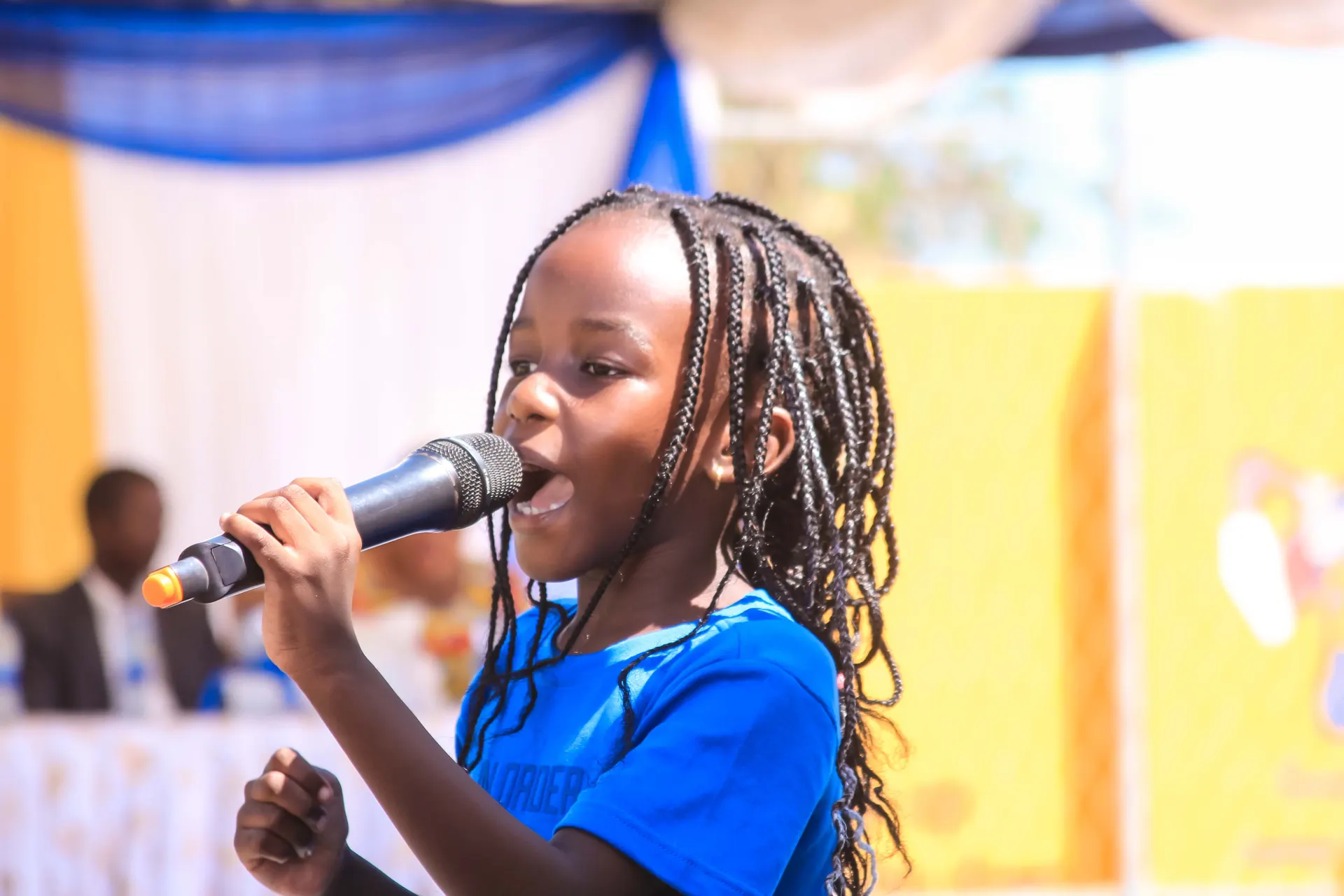 A young singer at the graduation celebration.