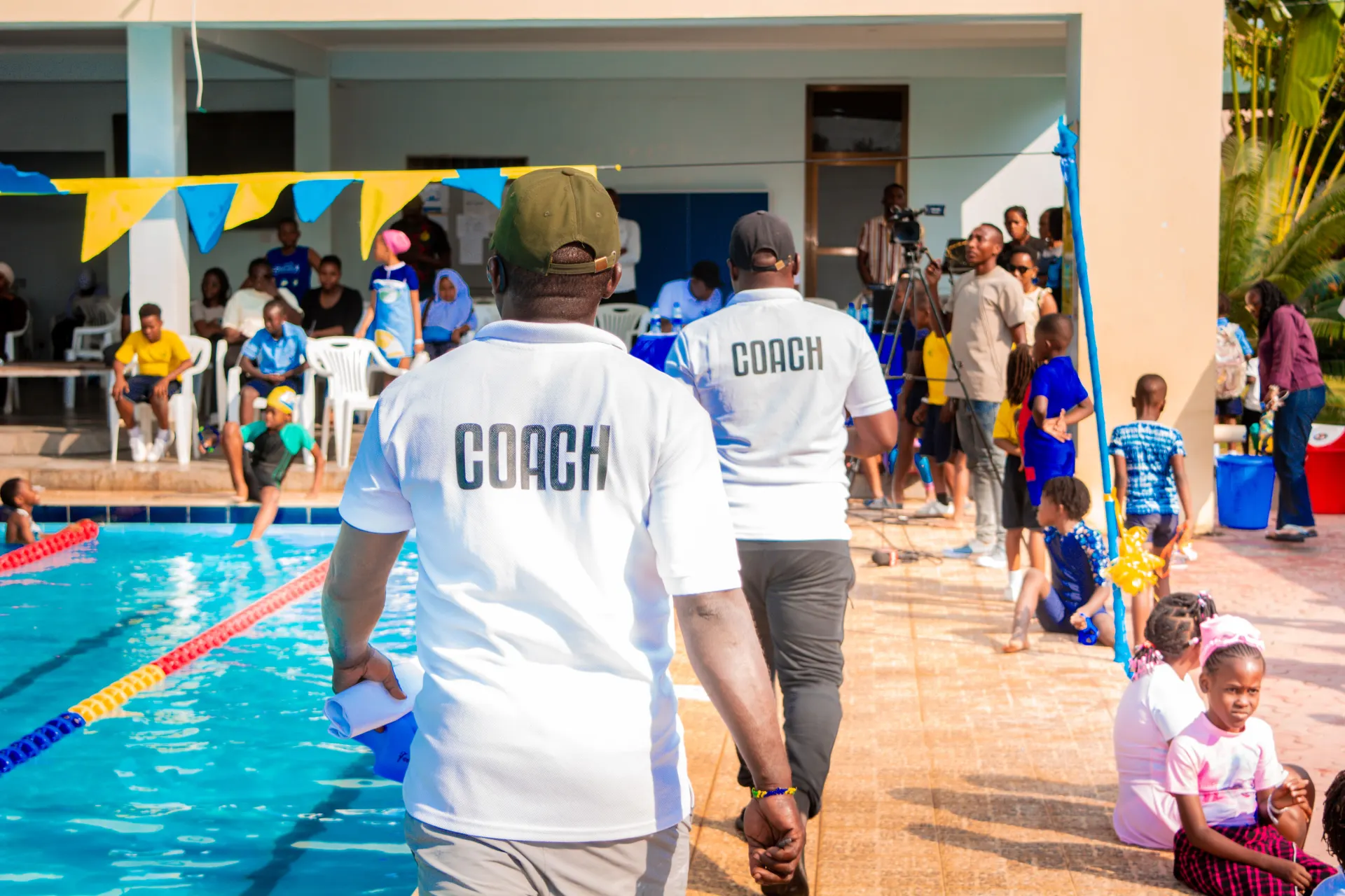 Coaches supporting learners during the swimming gala.