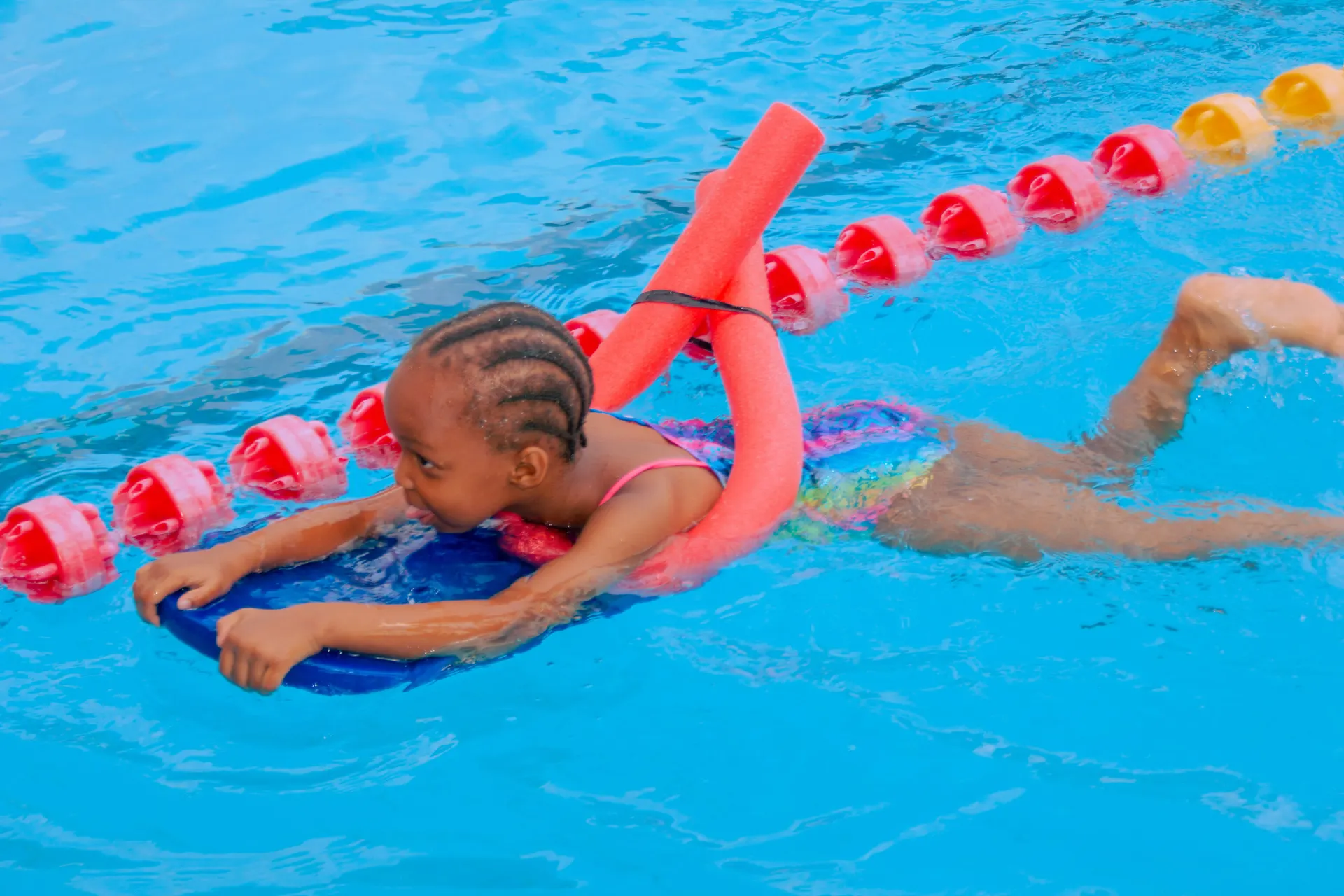 A young swimmer building confidence in the pool.
